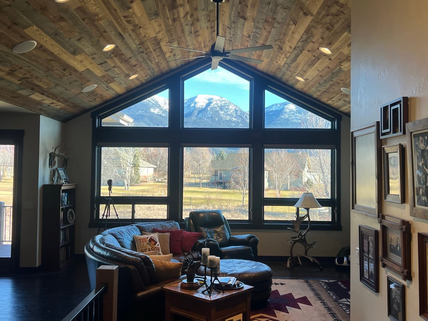 Great room with vaulted wood ceiling and mountain views